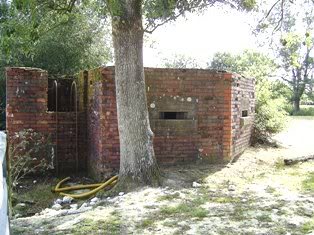 West aspect showing ladder and raised porch.