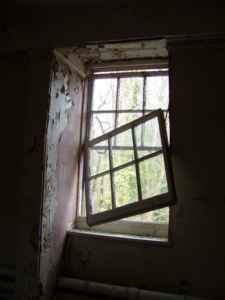 A broken sash window in one of the bedrooms